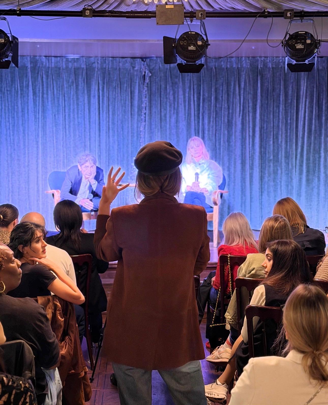 An audience member asking a question during a live conversation